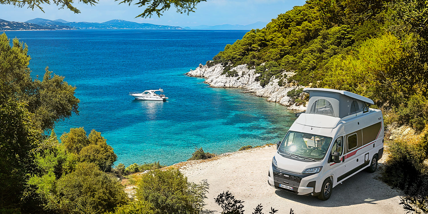 fourgon aménagé Pilote surplombant une mer turquoise